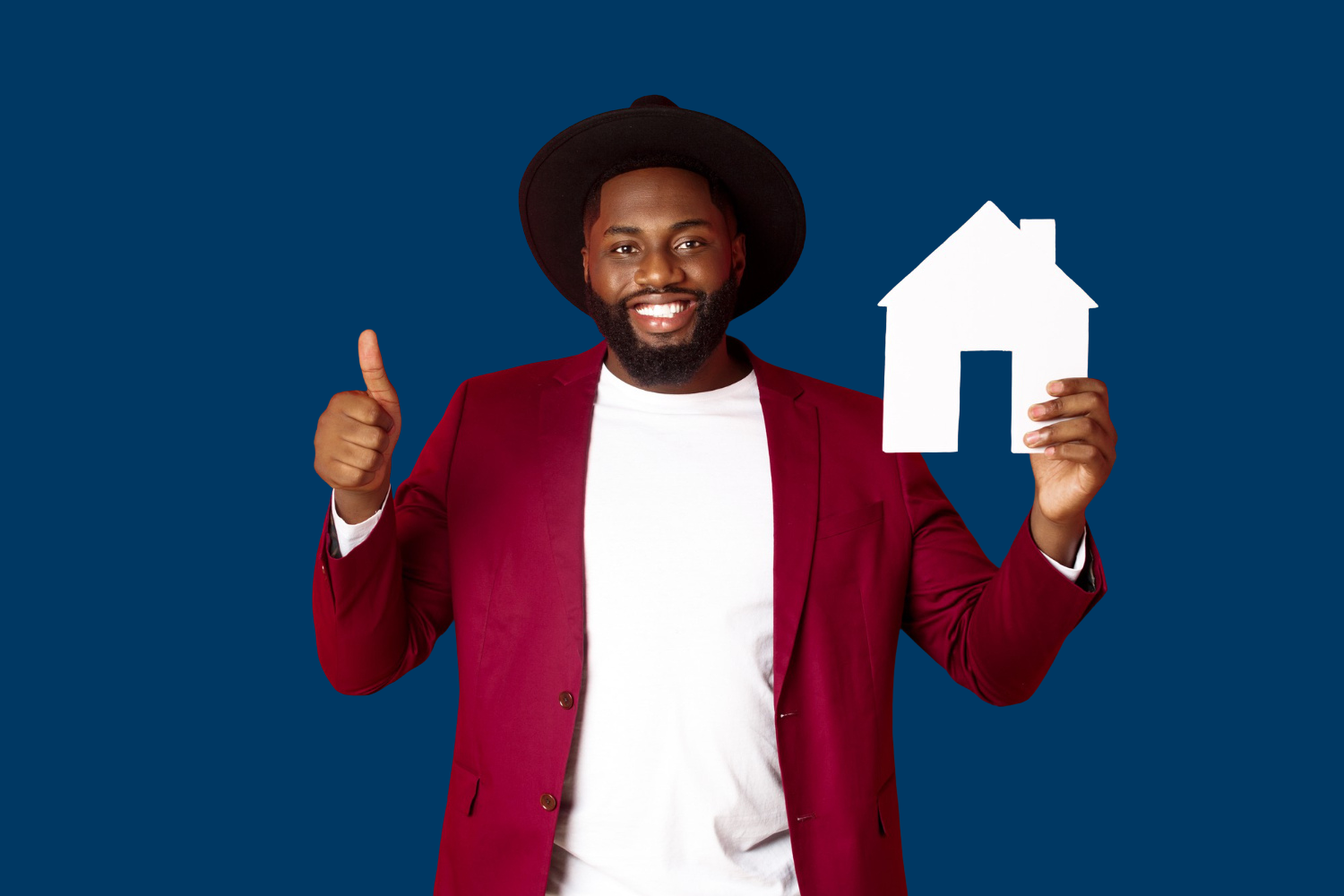 Image of a happy man giving a thumbs up and holding a house model